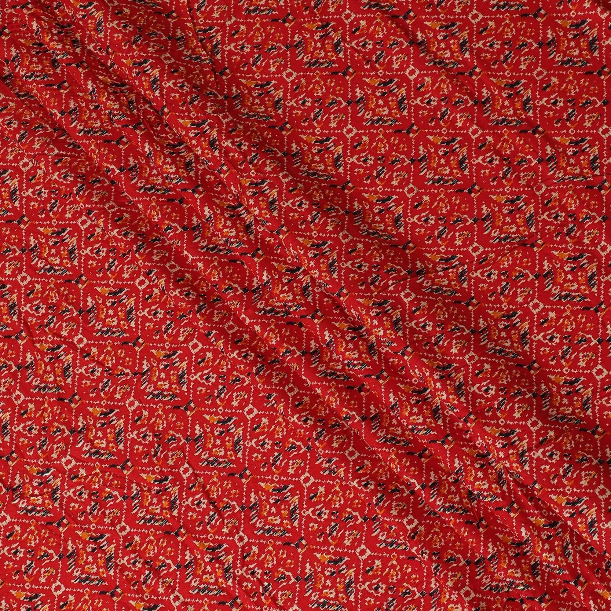 Crimson red cotton viscose fabric with black, orange and gold print in batik design-D14192