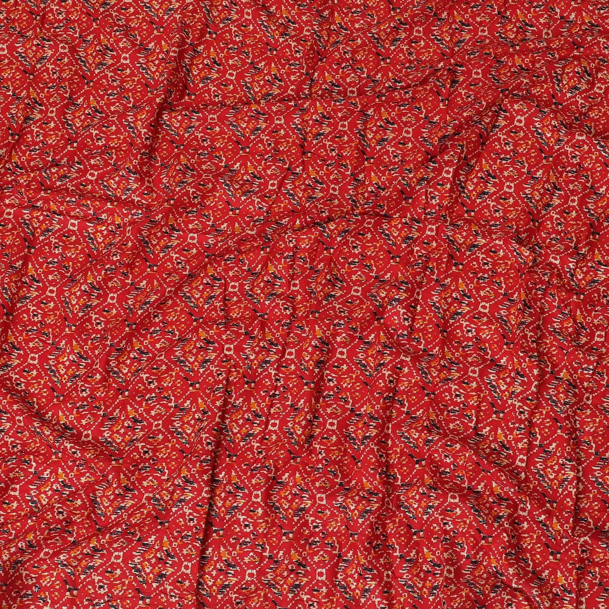 Crimson red cotton viscose fabric with black, orange and gold print in batik design-D14192